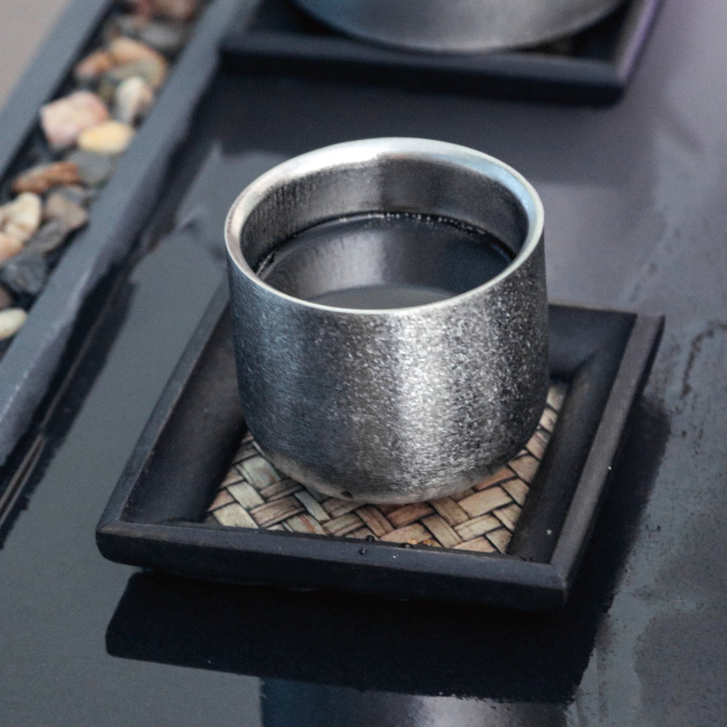 SilerAnt Outdoors Titanium Tea Cup Double Wall 125ml/4.22 fl oz Crystallized Finish in-use image placed on a tea cup plate