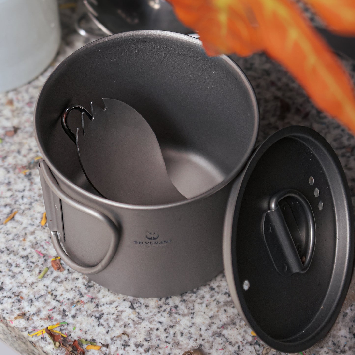 Ultralight Titanium Folding Spork with sandblasted finish folded and put in a titanium cup