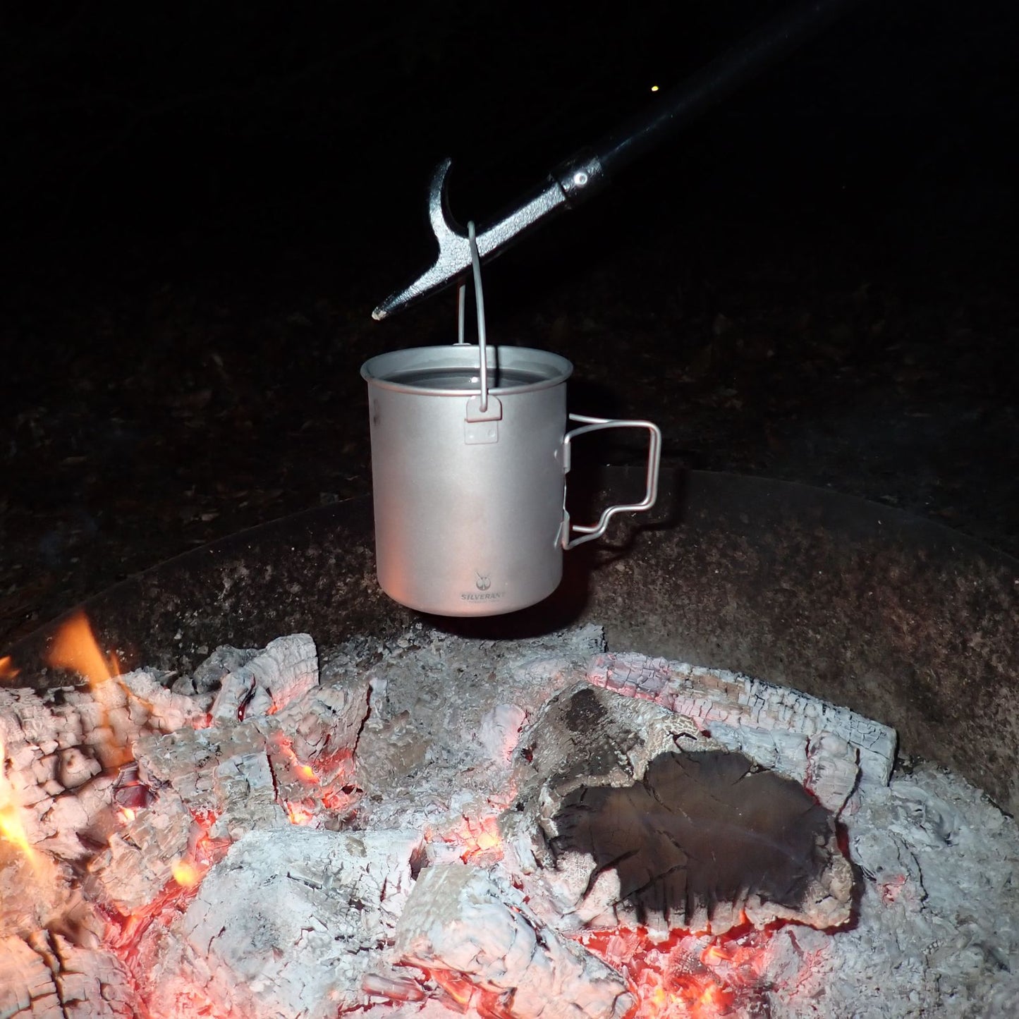 
                  
                    Titanium Pot 750ml/25 fl oz with Lid and Bail Handle - boliling water above campfire
                  
                