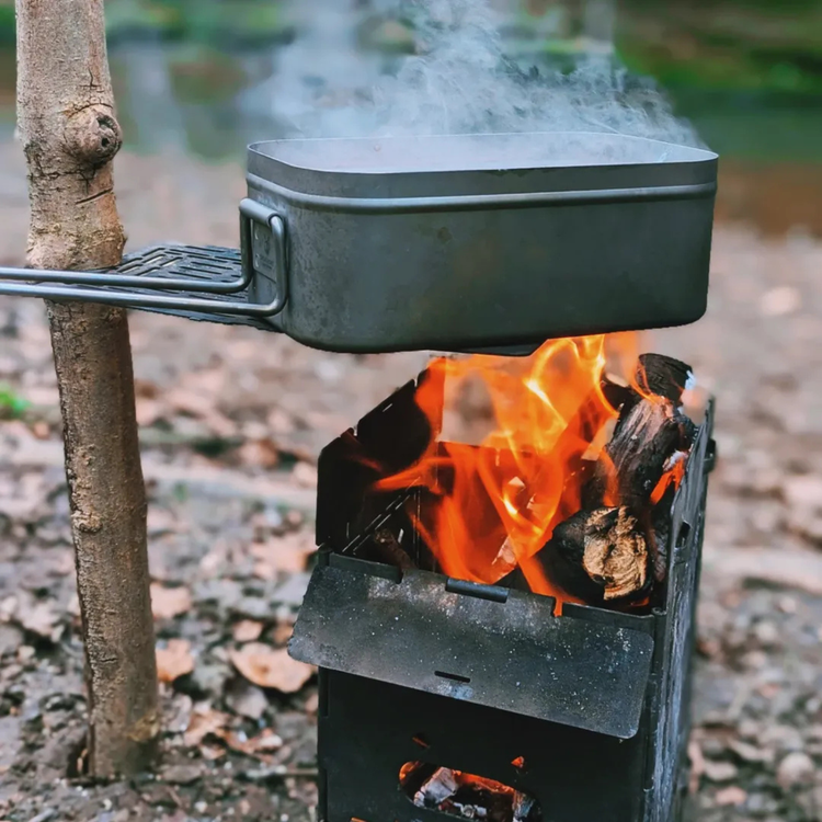 Titanium mess tin over campfire