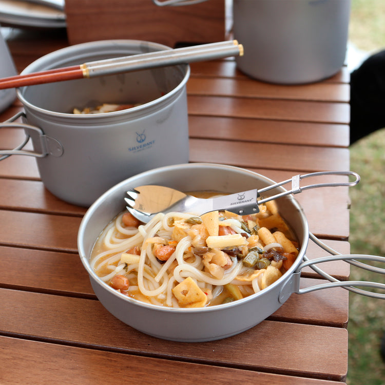 
                  
                    Ultralight Titanium Folding Spork with polished finish used for eating
                  
                