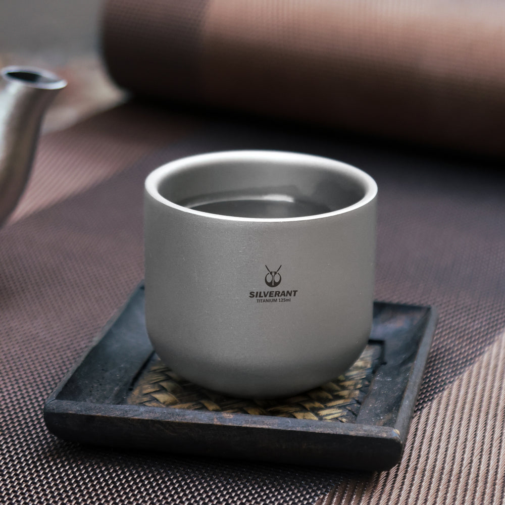 
                  
                    SilerAnt Outdoors Titanium Tea Cup Double Wall 125ml/4.22 fl oz Sandblasted Finish in-use image placed on the tea cup plate
                  
                