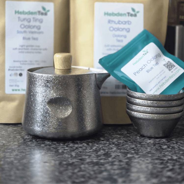 
                  
                    SilverAnt Crystallized Titanium Breeze Travel Teapot & Cups Set - actual product photo, real life setting, lifestyle shot, tea packs in the background
                  
                