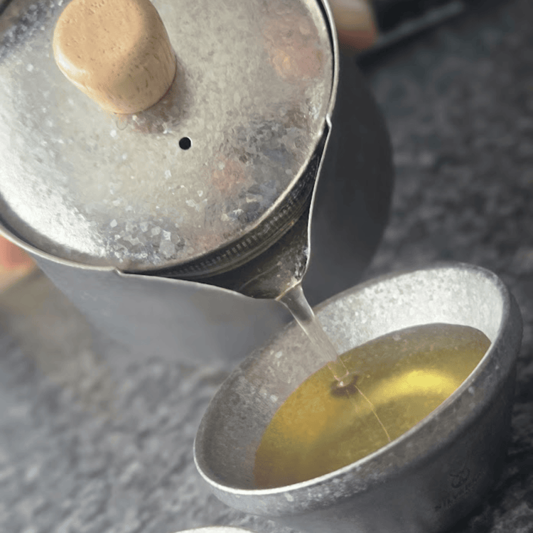 
                  
                    SilverAnt Crystallized Titanium Breeze Travel Teapot & Cups Set - actual product photo, pouring tea onto a cup, angled photo
                  
                