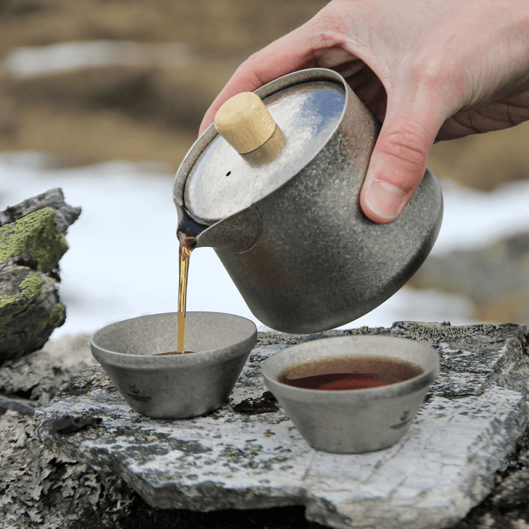 
                  
                    SilverAnt Crystallized Titanium Breeze Travel Teapot & Cups Set - actual product photo, pouring tea onto a cup, real life use, in use, lifestyle shot
                  
                