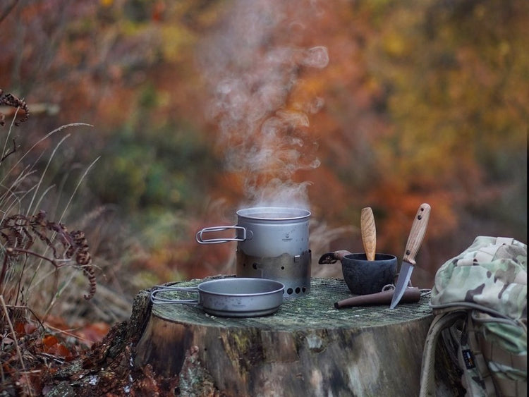 SilverAnt pot and pan set boiling water with steam and knives with an autumnal background