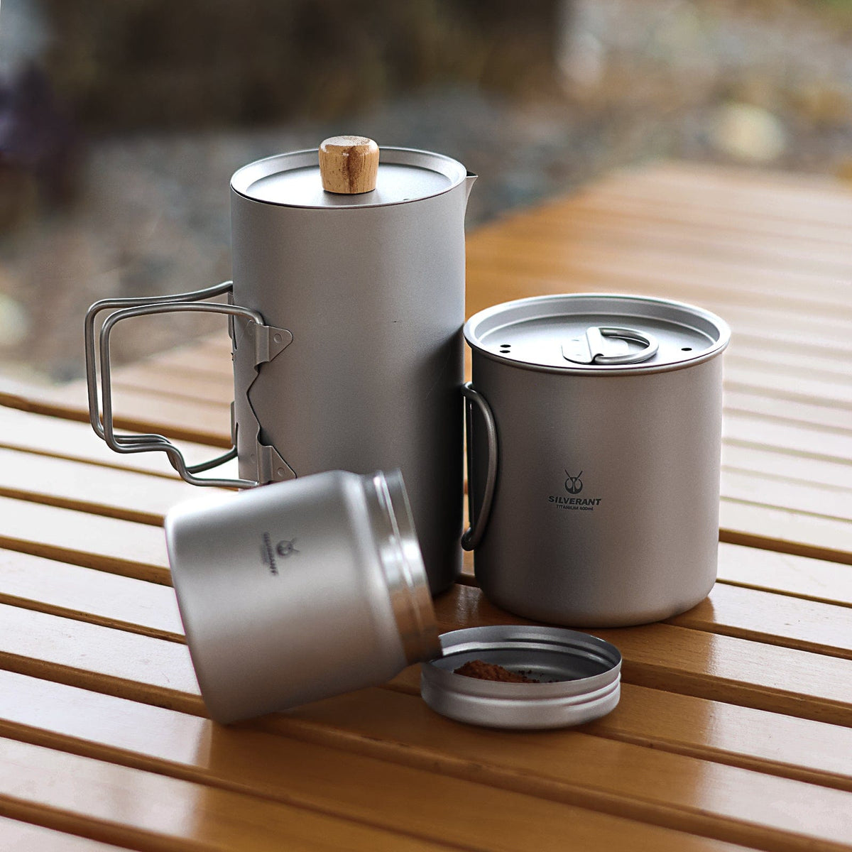 SilverAnt Titanium Coffee French Press Kit with Cup & Grounds Container - Lifestyle shot, actual product photo, professional shot, real life setting, set down on a wooden table