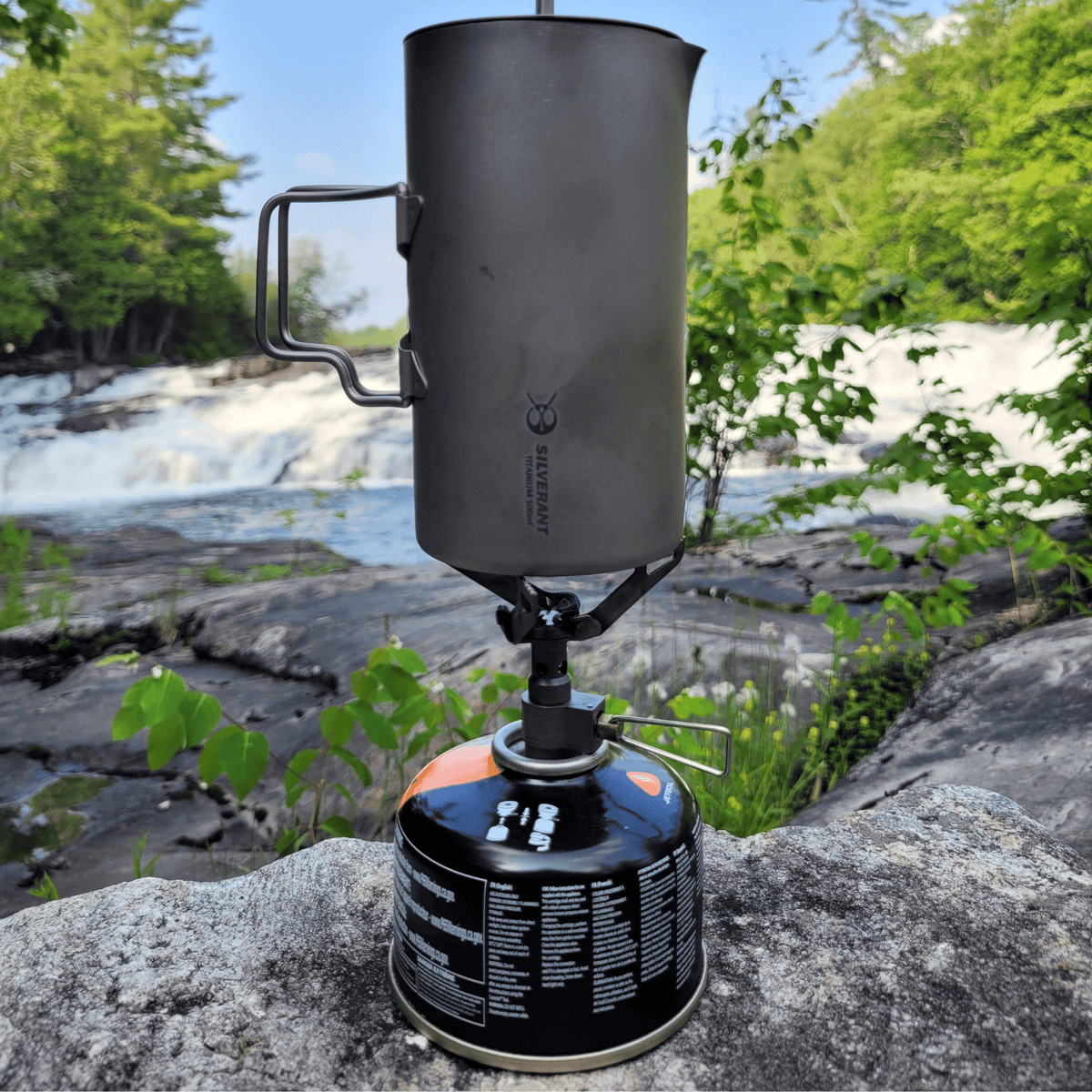 SilverAnt Titanium Coffee French Press Kit with Cup & Grounds Container - Coffee French Press on a gas stove, actual product photo, real life use, in use, lifestyle shot