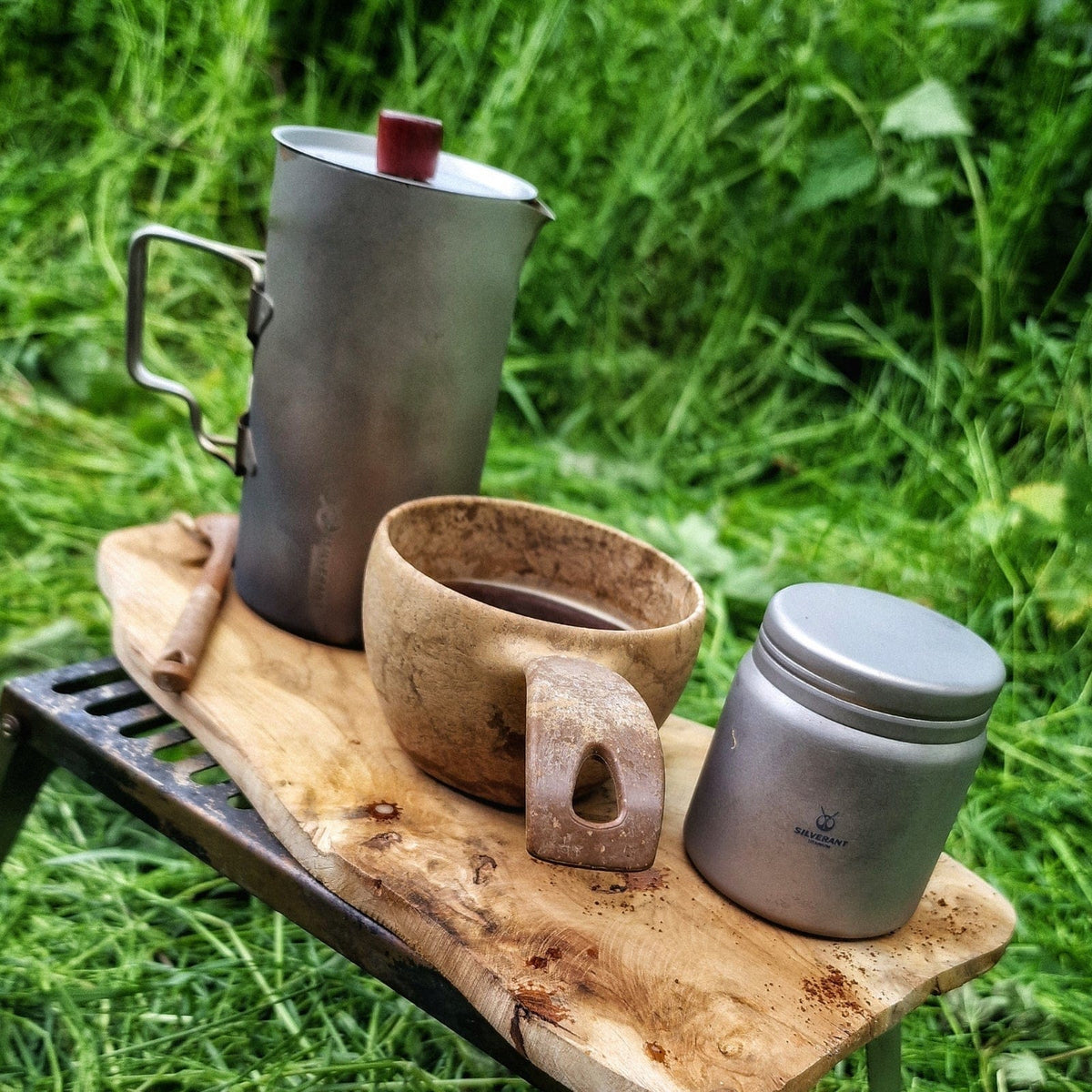 SilverAnt Titanium Coffee French Press Kit with Cup & Grounds Container - Coffee French Press and Grounds Container photographed with wooden coffee cup, Camp coffee set-up, real life still, real life setting, in use, actual product photo