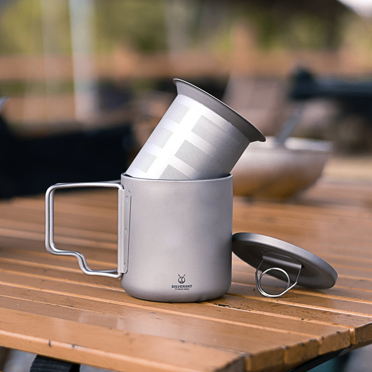 SilverAnt Titanium Double Wall Mug 300ml/10.14fl oz  - with folding handles - Actual product photo, lifestyle shot, showing filter on top of it, placed on a wooden table