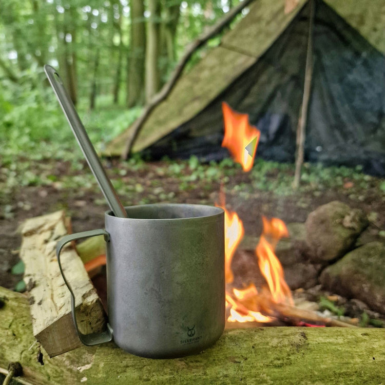 
                  
                    SilverAnt Titanium Double Wall Mug 300ml/10.14fl oz Classic Handles - Actual product photo, on a wooden branch with campfire in the background, real life still, lifestyle shot
                  
                