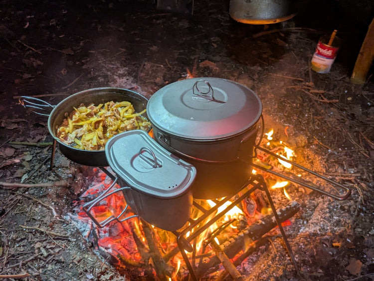 SilverAnt Products on an open fire at nighttime with flames glowing