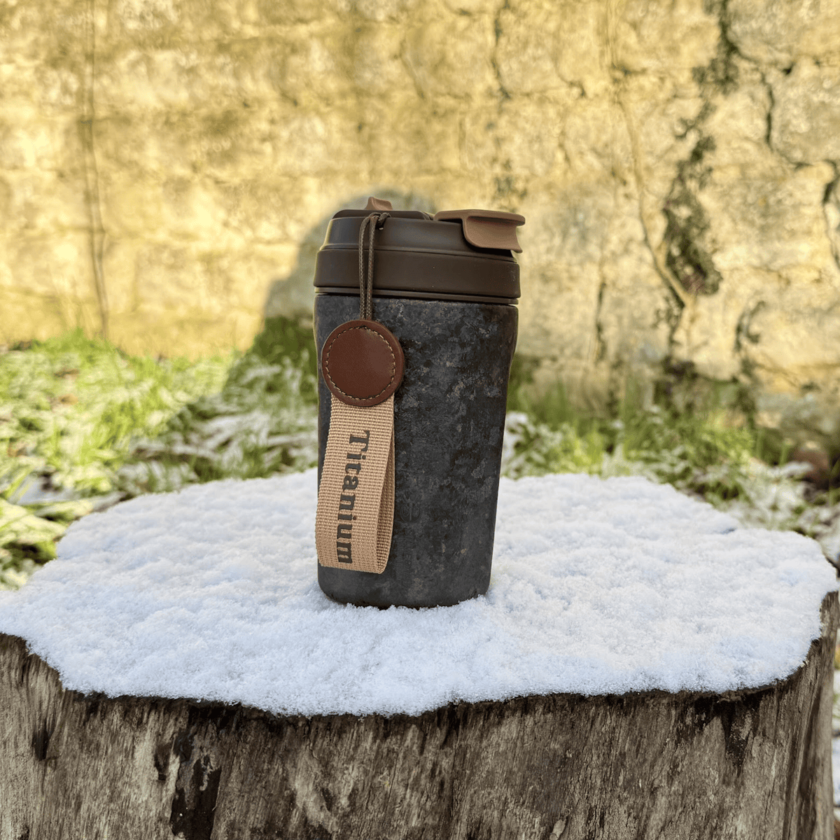 SilverAnt Ultralight Crystallized Titanium Insulated Travel Coffee Mug with Lid 400ml/14 fl oz Black Crystallized - Actual product photo, on a snowy tree stump, real life still, lifestyle shot