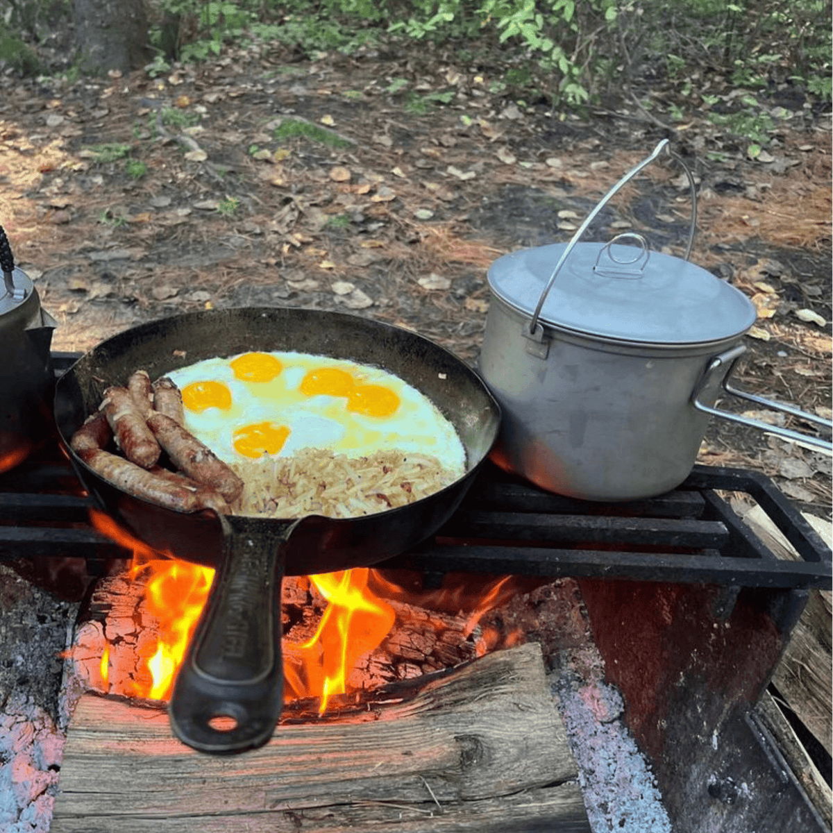 SilverAnt Ultralight Large Titanium Camping Pot with Lid & Bail Handle 2L/67.63 fl oz - In-Use (cooking beside cast iron pan, over fire, outdoors)