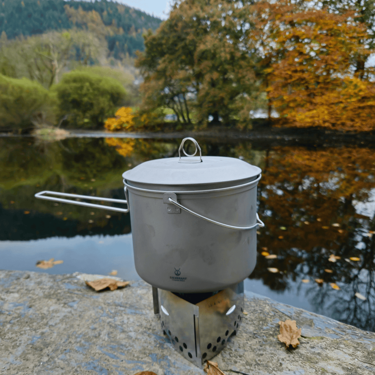 SilverAnt Ultralight Large Titanium Camping Pot with Lid & Bail Handle 2L/67.63 fl oz - In-Use (Lake background, autumn, fall camping, outdoors setting)