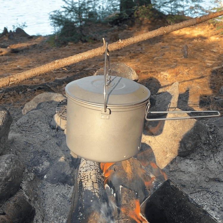 
                  
                    SilverAnt Ultralight Large Titanium Camping Pot with Lid & Bail Handle 2L/67.63 fl oz - In-Use (hanging over fire with a stick)
                  
                
