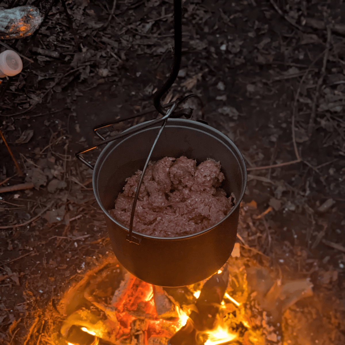 SilverAnt Ultralight Large Titanium Camping Pot with Lid & Bail Handle 2L/67.63 fl oz - In-Use (hanging over fire, cooking ground beef, camp cooking, camp dinner)