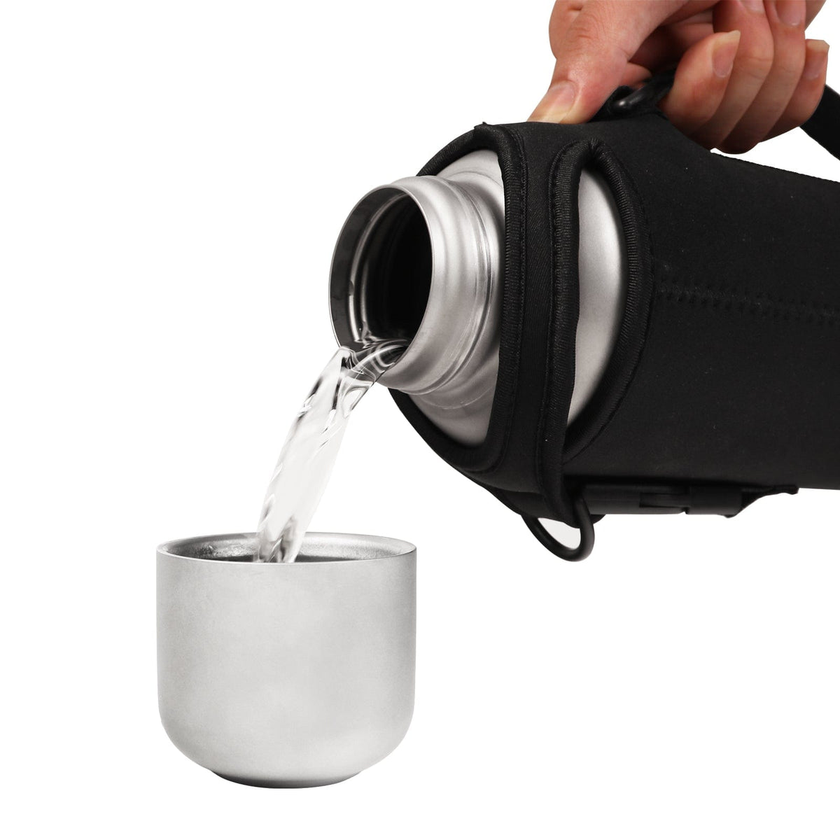 SilverAnt Ultralight Large Titanium Water Bottle With Titanium Cup - pouring water onto lid cup using the black thermal sleeve as easy-pour handle