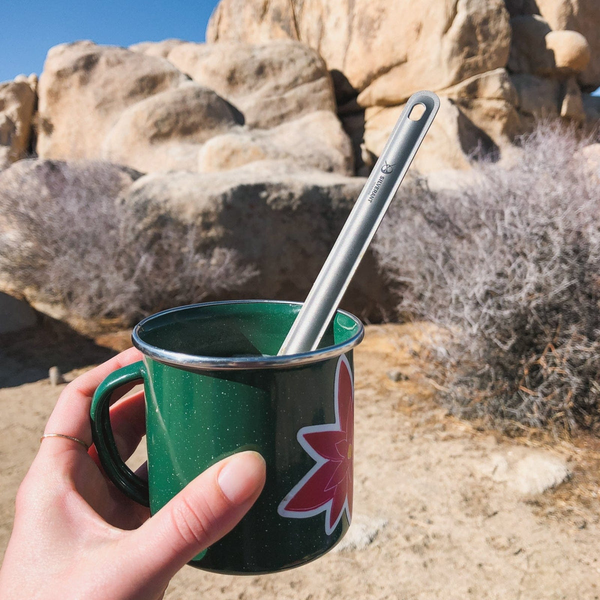 SilverAnt Ultralight Long Handle Titanium Spoon - actual product photo, real life use, in use, on green mug in the outdoors
