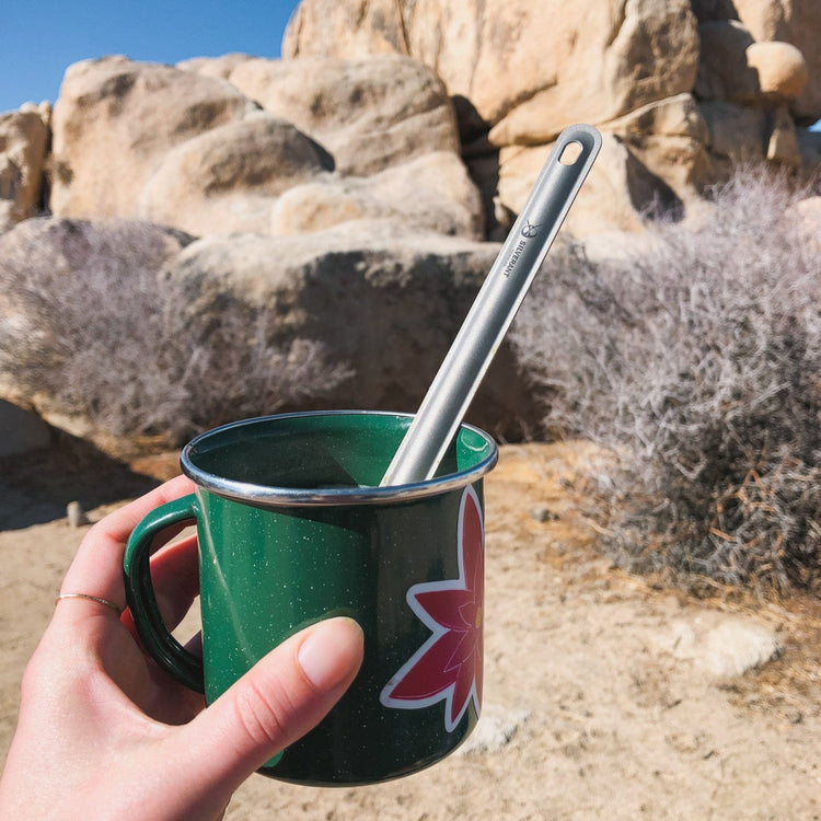 
                  
                    SilverAnt Ultralight Long Handle Titanium Spoon - actual product photo, real life use, in use, on green mug in the outdoors
                  
                