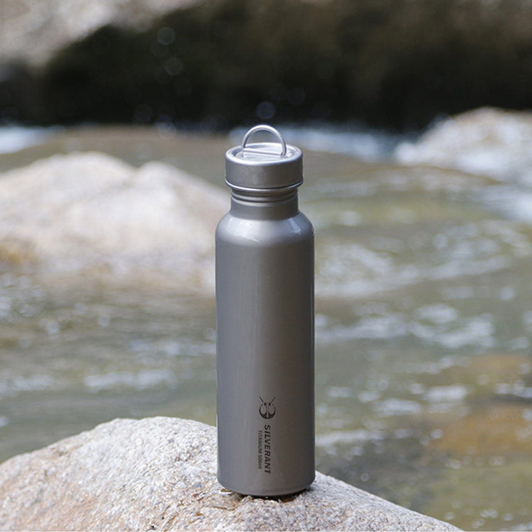 
                  
                    SilverAnt Ultralight Round Titanium Water Bottle - 500ml - In-Use (actual product photo, pictured in front of river)
                  
                