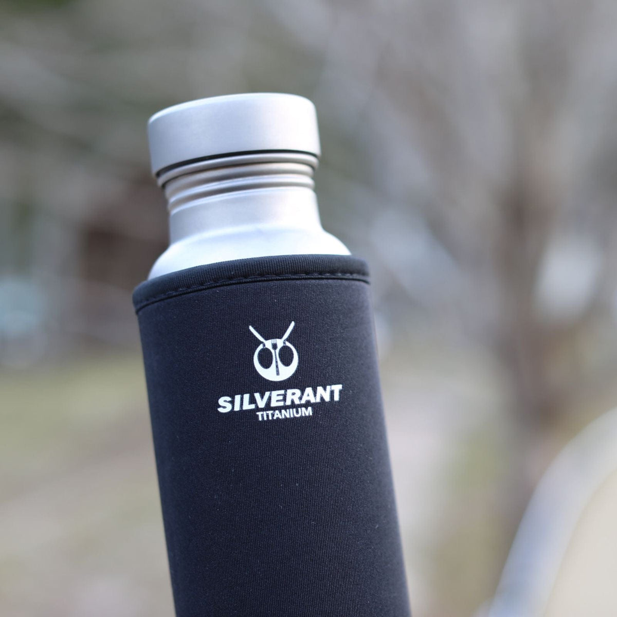 SilverAnt Ultralight Round Titanium Water Bottle - In-Use (actual product photo, close-up of black thermal sleeve with SilverAnt branding, lid)