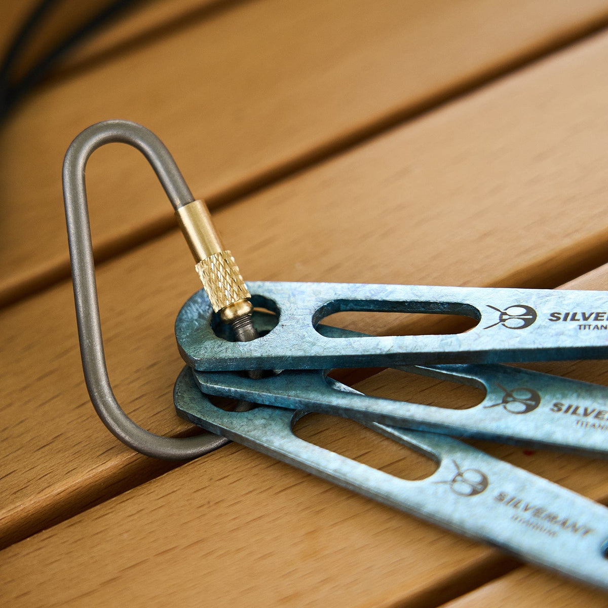 SilverAnt Ultralight Titanium 3-Piece Cutlery Set (Kinfe, Fork, and Spoon) Anodized Blue - actual product photo, close-up of carabiner hook, silverant branding