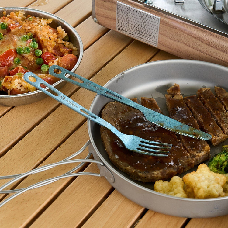 
                  
                    SilverAnt Ultralight Titanium 3-Piece Cutlery Set (Kinfe, Fork, and Spoon) Anodized Blue - actual product photo, real life, in-use, eating steak, lifestyle shot
                  
                