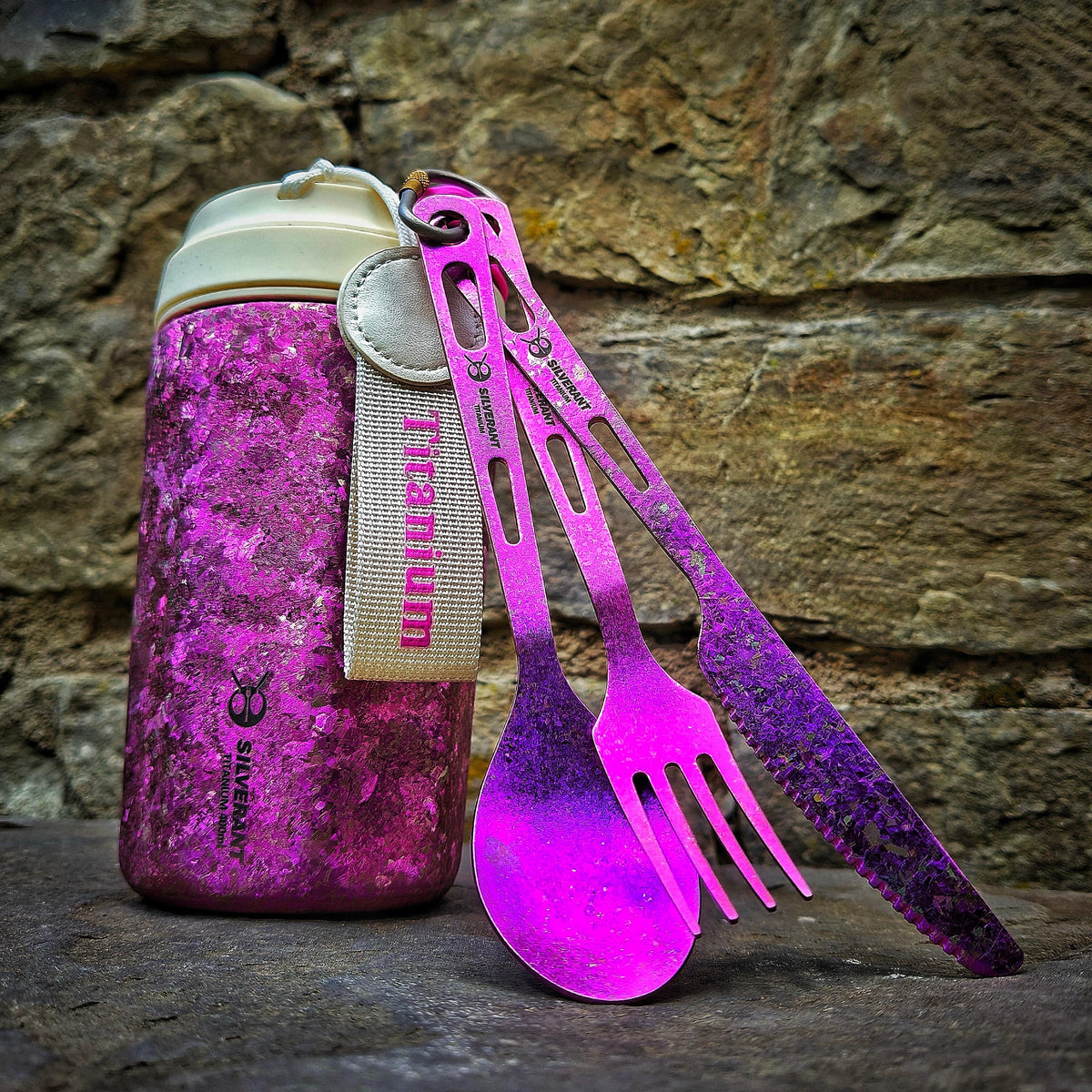 SilverAnt Ultralight Titanium 3-Piece Cutlery Set (Knife, Fork and Spoon) Anodized Purple - actual product photo, lifestyle shot, outdoors, real life setting, with anodized purple silverant coffee mug in the background