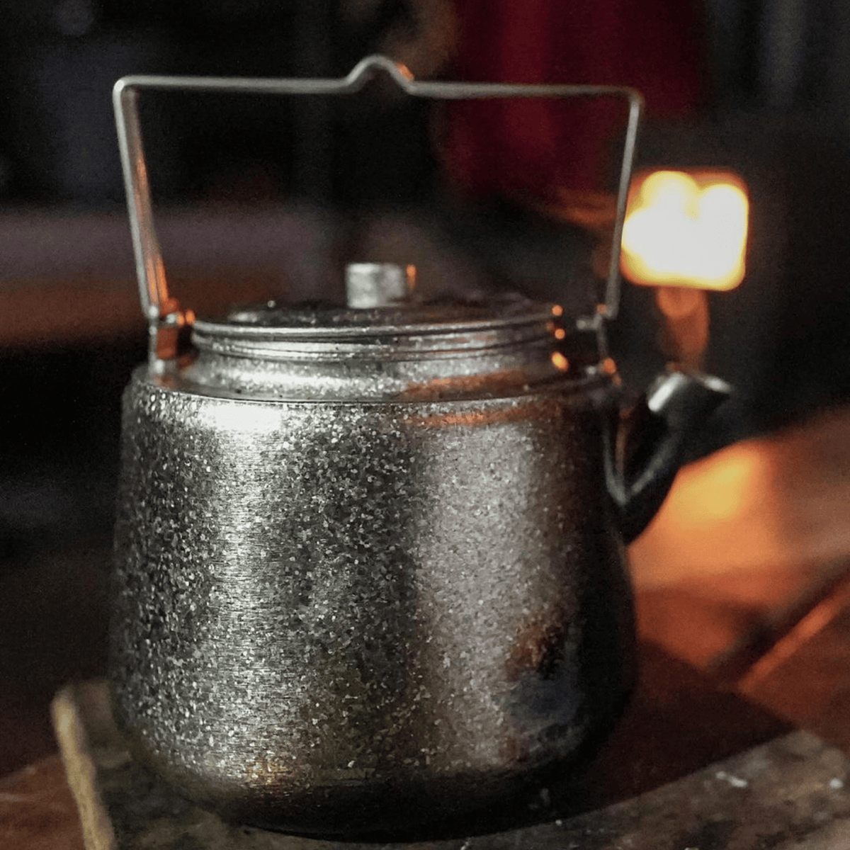 SilverAnt Ultralight Titanium Bushcraft Kettle Crystallized Finish 1500ml - In-Use (on a table, cozy setting)