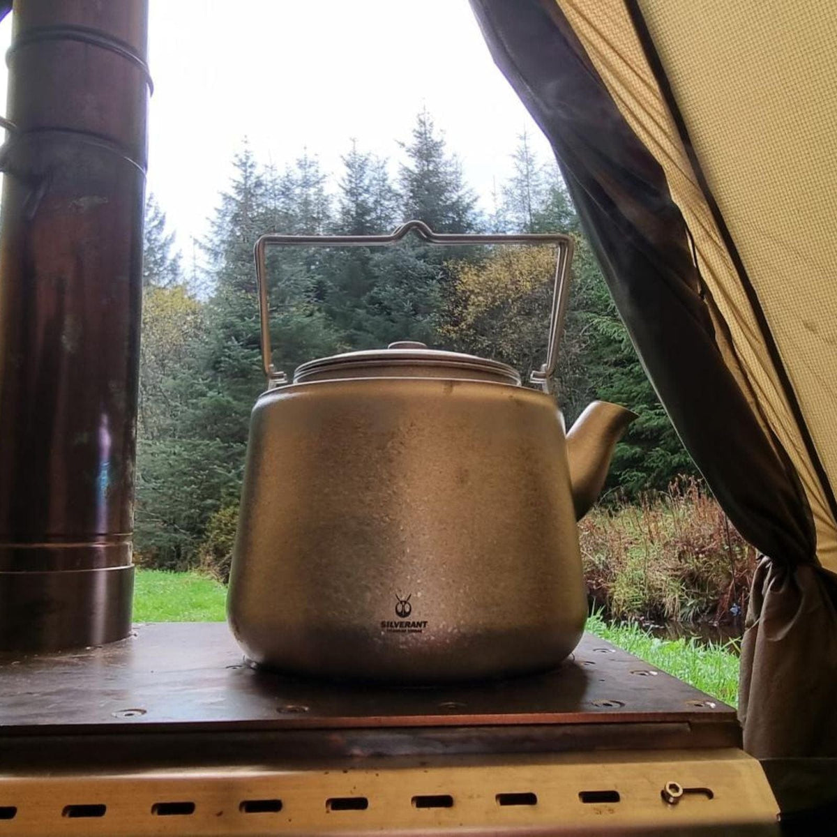 SilverAnt Ultralight Titanium Bushcraft Kettle Crystallized Finish - In-Use (Forest background, on the tent stove)