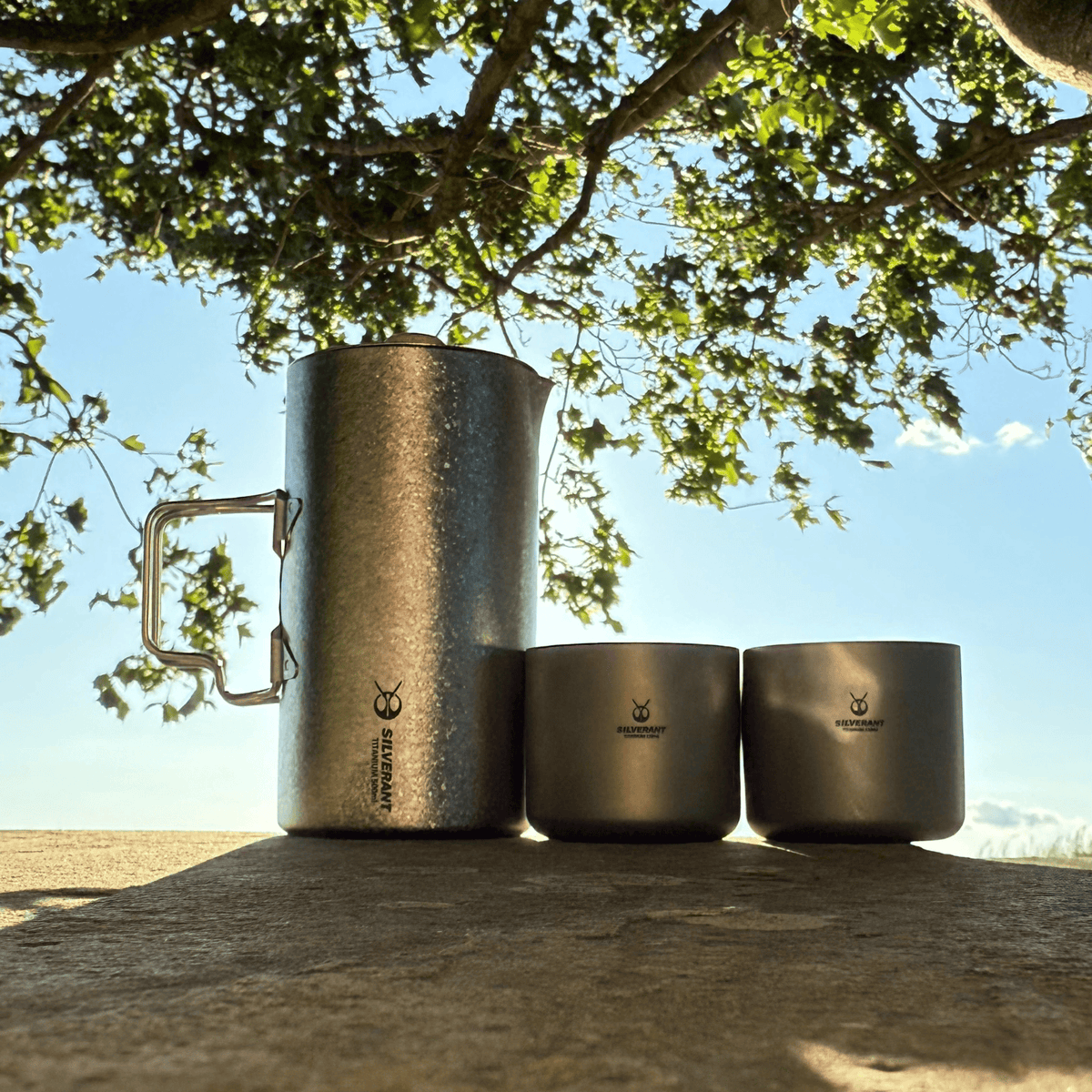 SilverAnt Ultralight Titanium Coffee French Press Crystallized - Actual product photo, lifestyle shot, on a canopy, with two SilverAnt Titanium Coffee Cups