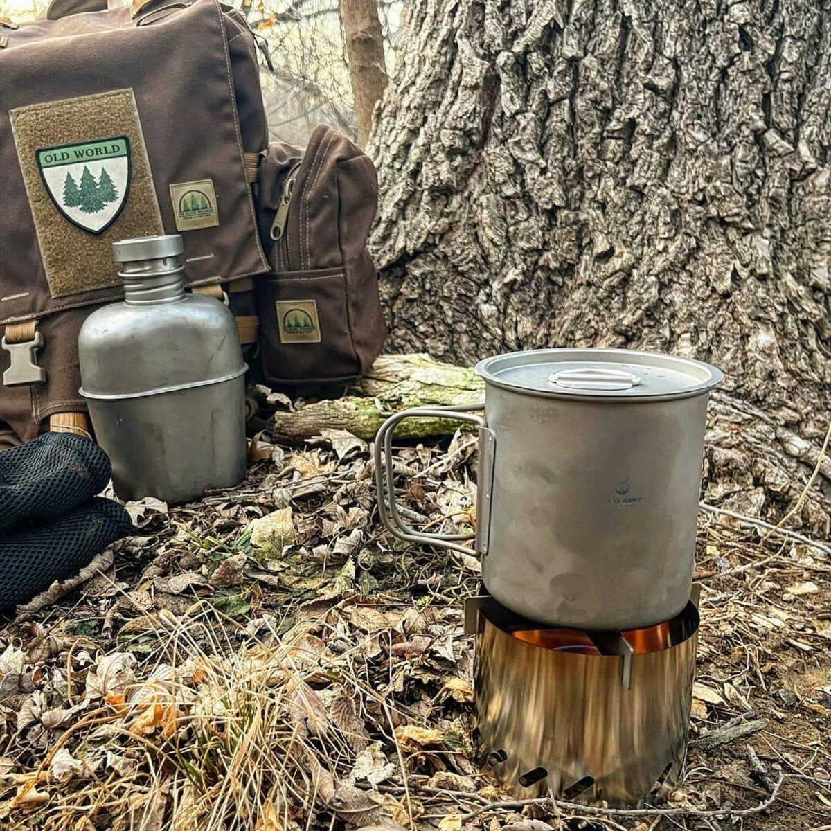 SilverAnt Ultralight Titanium Cup With Lid 4 Sizes 600ml - Actual product photo, real life still, lifestyle shot, placed on an alcohol stove with cross stand and windshield