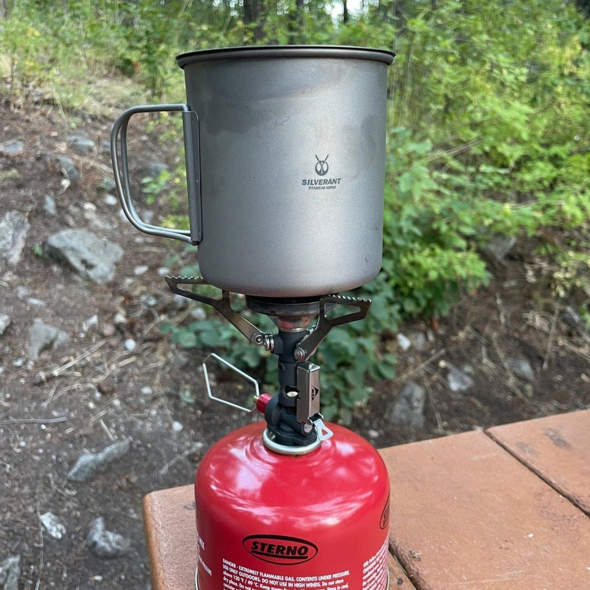 SilverAnt Ultralight Titanium Cup With Lid 4 Sizes - 600ml - Actual product photo, lifestyle shot, placed on top of stove, camp cooking