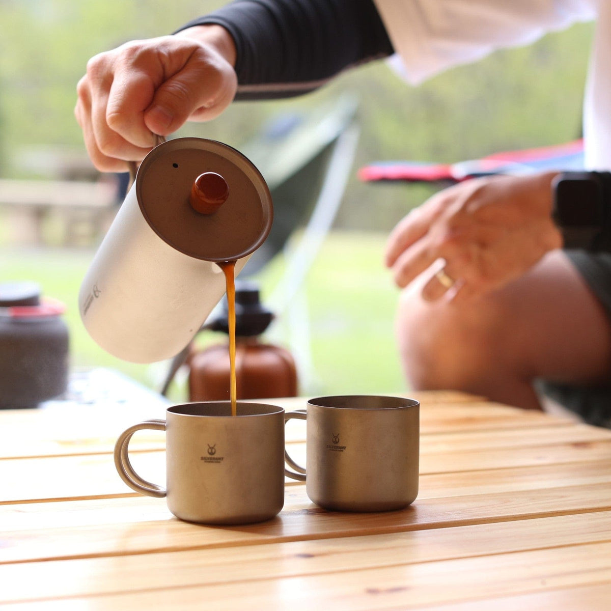 SilverAnt Ultralight Titanium Double Wall Espresso Coffee Cup 110ml/3.71 fl oz With Handle - Actual product photo, in use, real life still, real life setting, lifestyle shot, pouring coffee from SilverAnt Coffee French Press Sandblasted, camp coffee