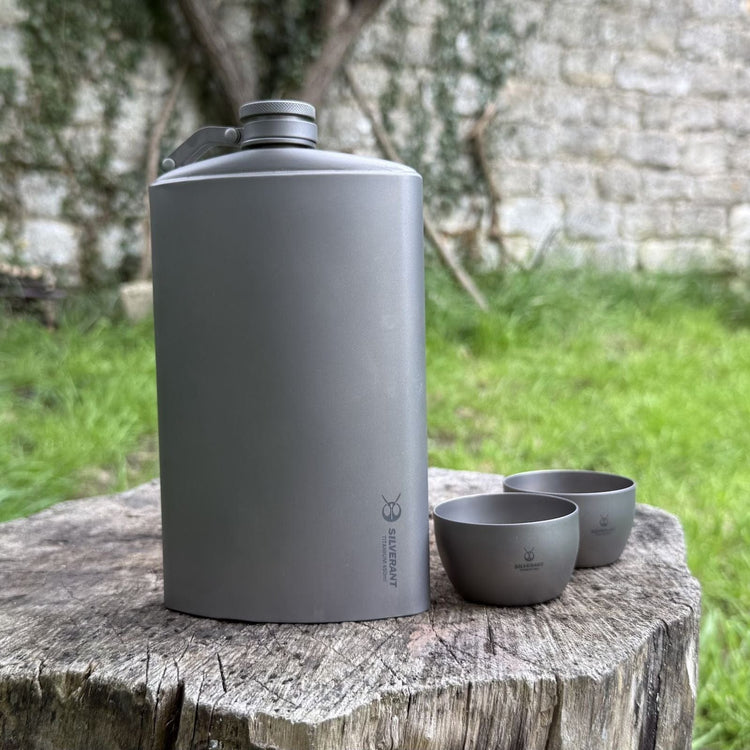 
                  
                    SilverAnt Ultralight Titanium Hip Flask 450ml/15.22 fl oz & Shot Glasses - Actual product photo, lifestyle shot, real life still, on a tree stump
                  
                