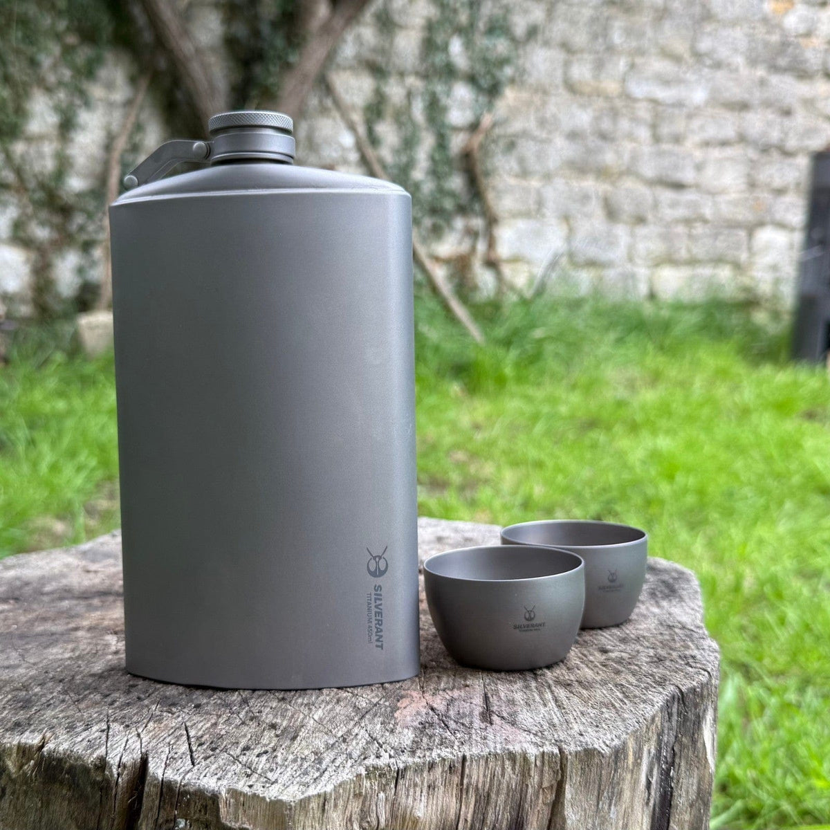 SilverAnt Ultralight Titanium Hip Flask & Funnel - 450ml/15.22 fl oz Sandblasted (actual product photo, placed on top of a wood stump)