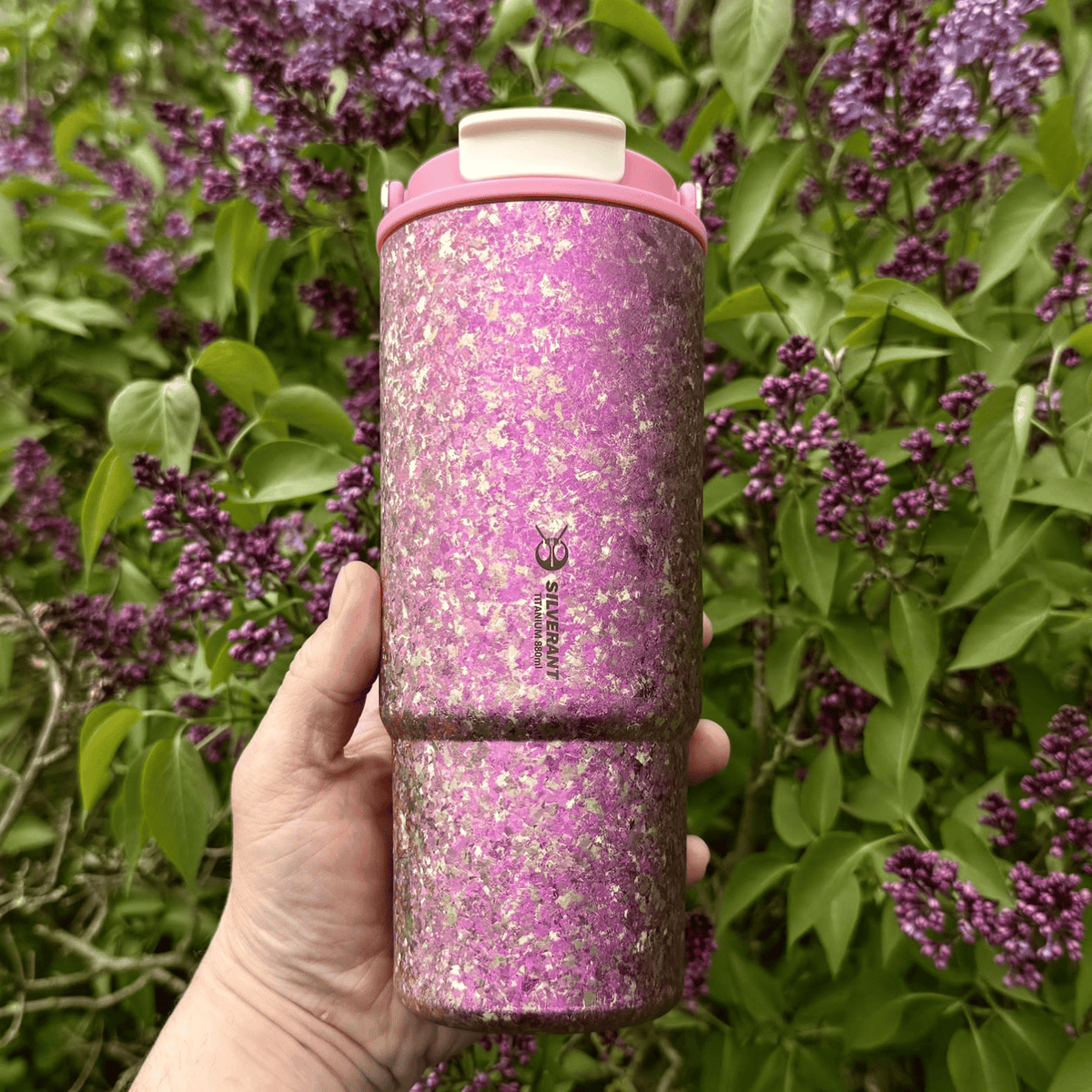 SilverAnt Crystallized Titanium Insulated Tumbler 880ml / 29.76 fl oz - Iridescent Pink (on-hand, actual product photo, with pink flowers in the background)