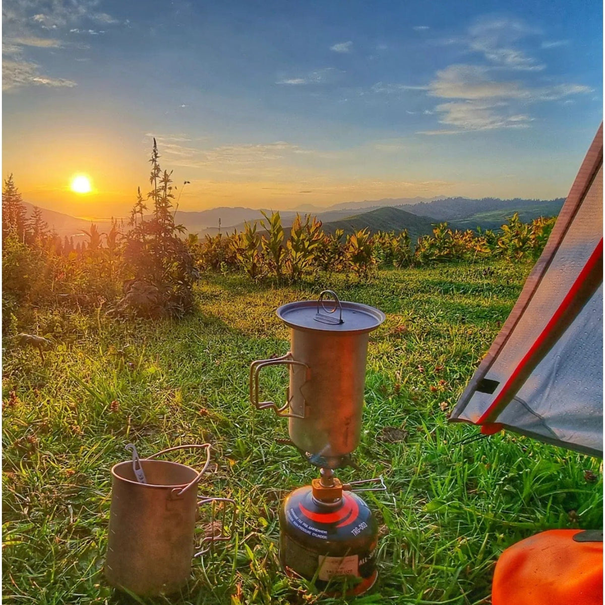 SilverAnt Ultralight Titanium Pot 750ml/25 fl oz with Lid and Bail Handle - In-Use (Mountain view, Sunset, beautiful background, grass clearing)