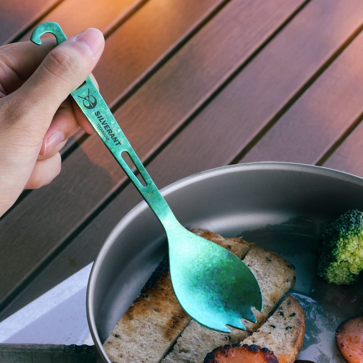 SilverAnt Ultralight Titanium Spork with Bottle Opener Anodized Green - actual product photo, on-hand, in-use, real life setting, lifestyle shot