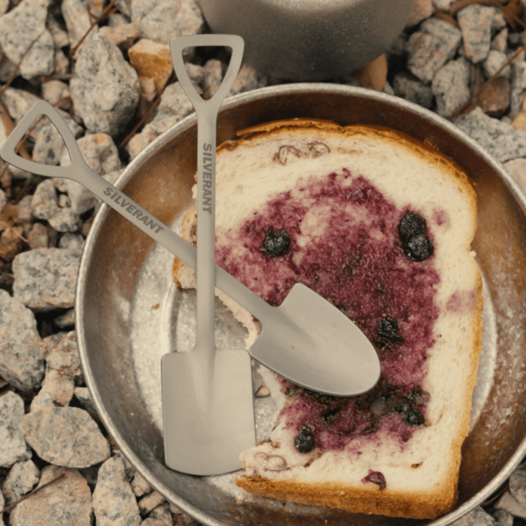 
                  
                    SilverAnt Ultralight Titanium Square & Spade Shovel Cutlery Utensils - Square and Spade shovel both in use, real life use, lifestyle photo, top angle view, with bread
                  
                