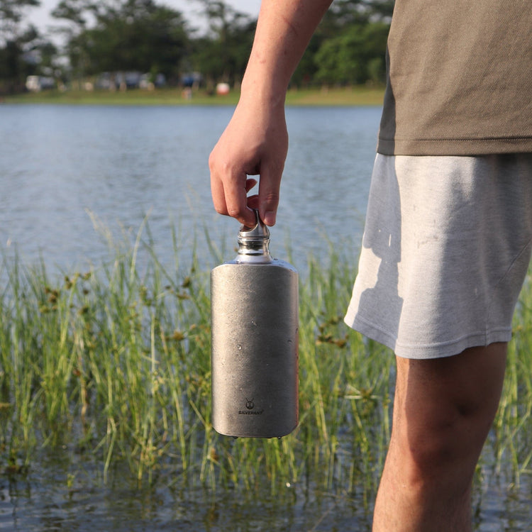 
                  
                    SilverAnt Ultralight Titanium Water Bottle 800ml/28.16 fl oz (Slim Crystallized) - In-Use (held by hand, lifestyle photo, camping)
                  
                
