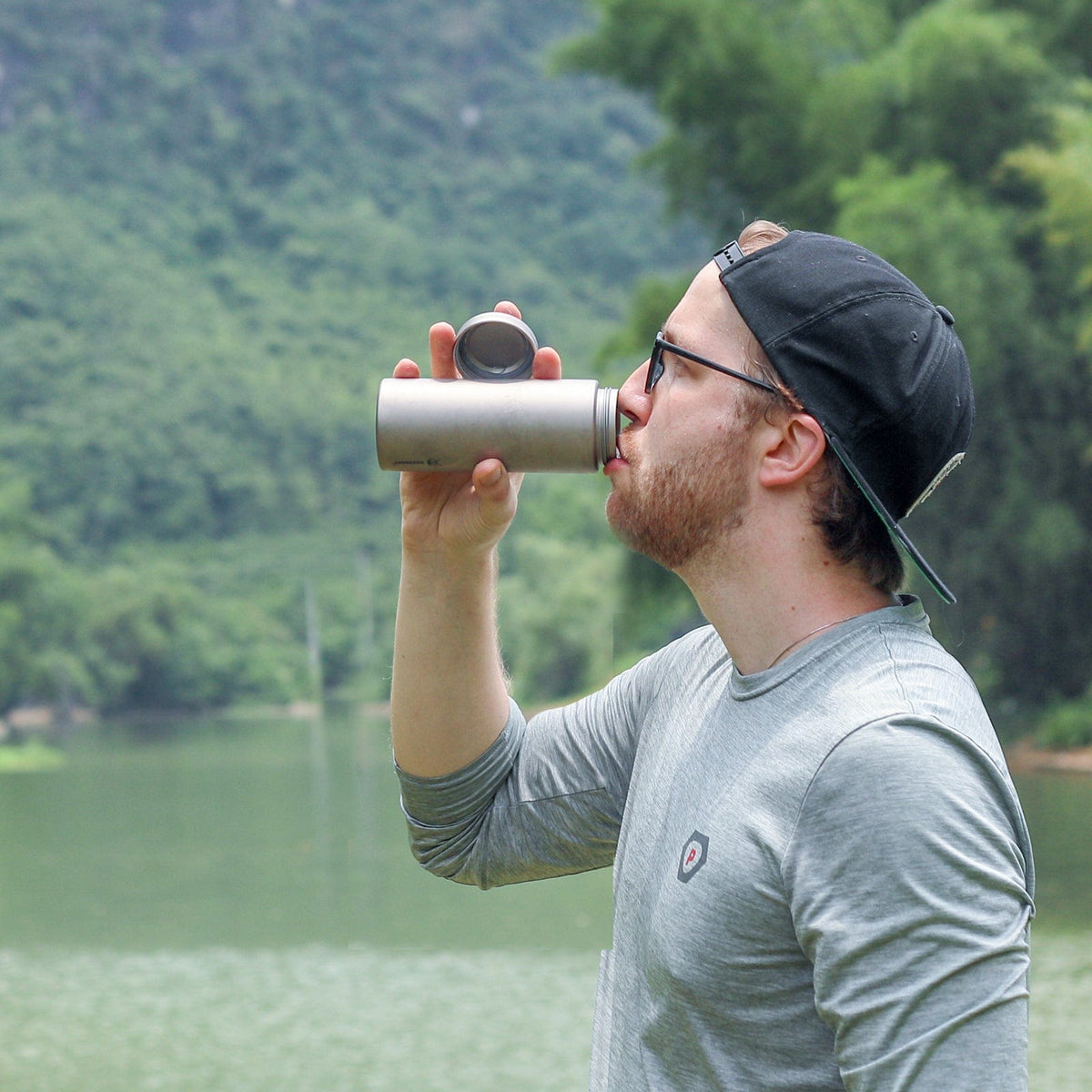 SilverAnt Ultralight Titanium Water Bottle Wide Mouth Screw Top - actual product photo, in-use, man drinking from bottle