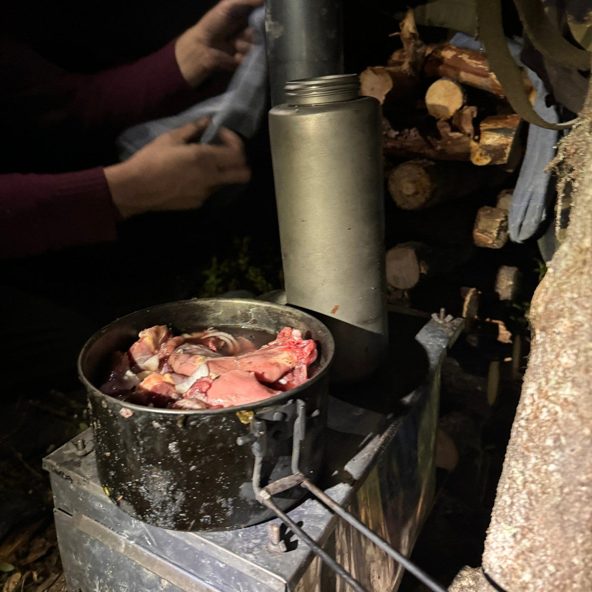 SilverAnt X 5Athlon Nomads Trails Collaboration - Large Titanium Wide Mouth Water Bottle actual product photo, in use, placed on top of tent stove