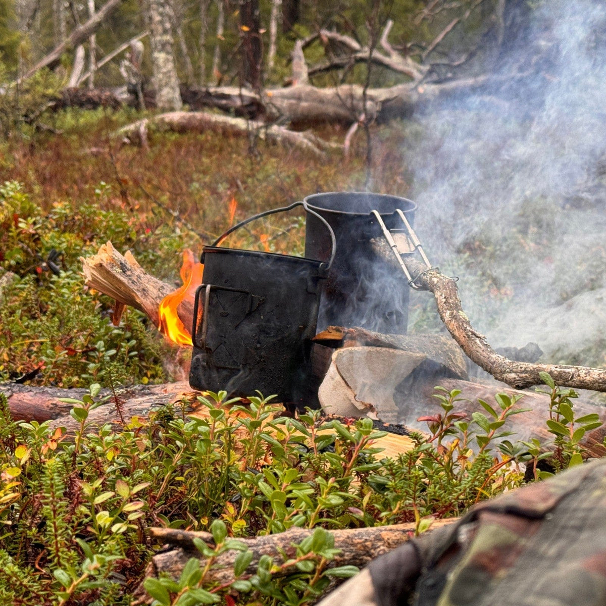 SilverAnt X 5Athlon Nomads Trails Collaboration - SilverAnt Titanium Cup and SilverAnt Titanium Pot placed on wood campfire