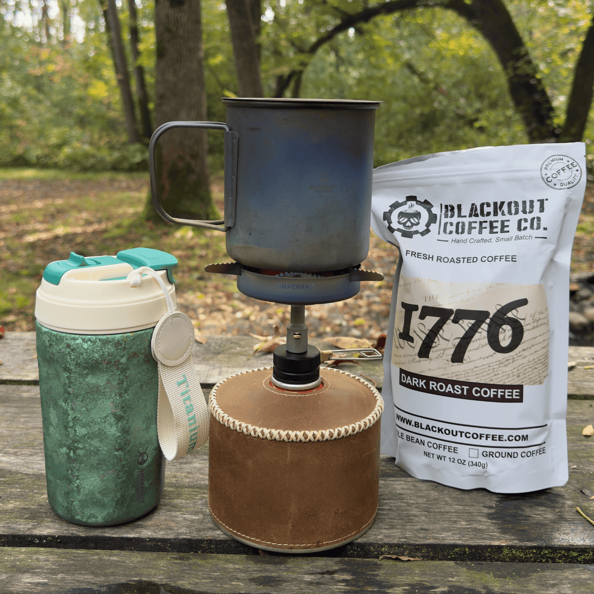SilverTi Ultralight Titanium Gas Stove - Actual product photo, with SilverAnt Titanium Cup on top, photographed outdoors, lifestyle photo