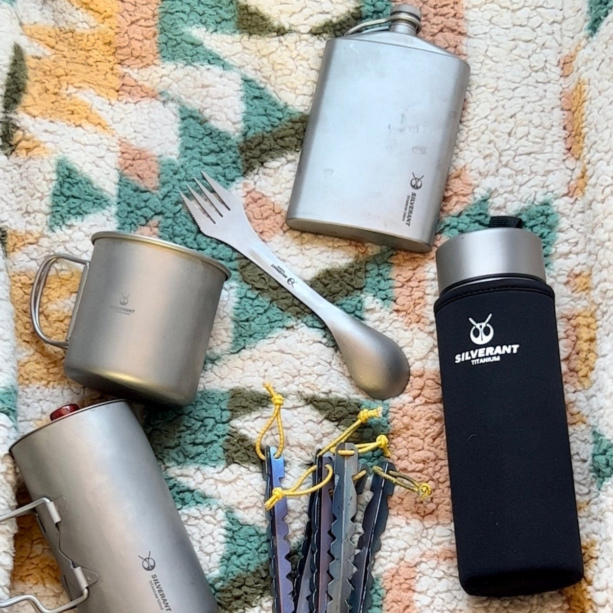 Titanium Double-Wall Insulated Thermos Flask 400ml/14fl oz - on the rug/carpet with other SilverAnt gear