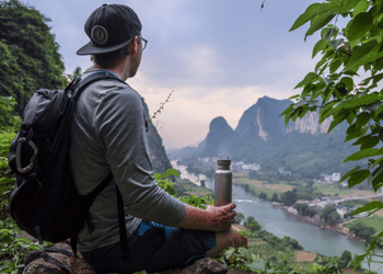 SilverAnt Outdoors Man Sat With River And Mountain Background Holding 800ml Titanium Water Bottle