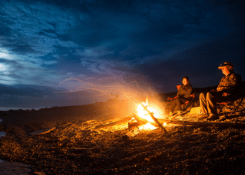 SilverAnt Outdoors Couple Sat With A Campfire On The Beach At Night