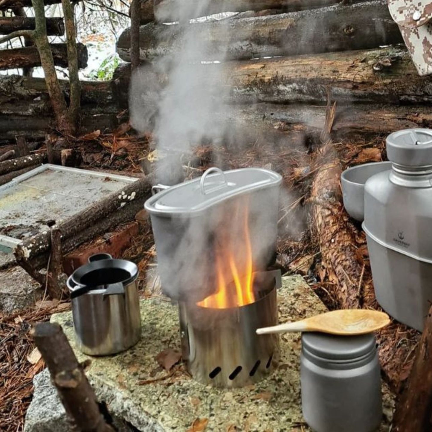 
                  
                    Ultralight Titanium Multi-Fuel Stove, Cross Stand & Windshield - boiling water in a tianium military cup
                  
                